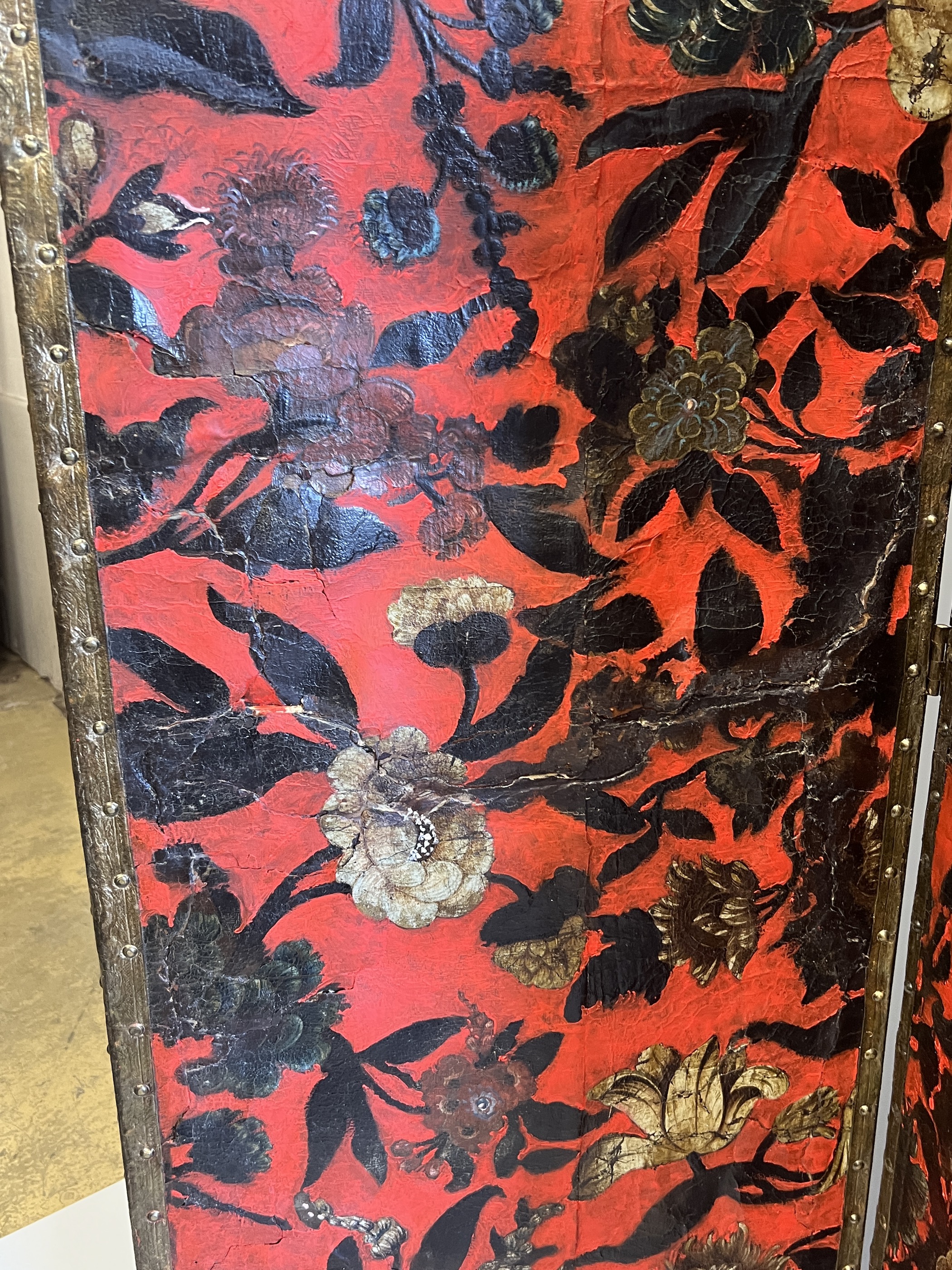 A 19th century Spanish leather three fold dressing screen re-painted by Ricardo Cinalli for the current owner, each panel width 57cm, height 175cm
